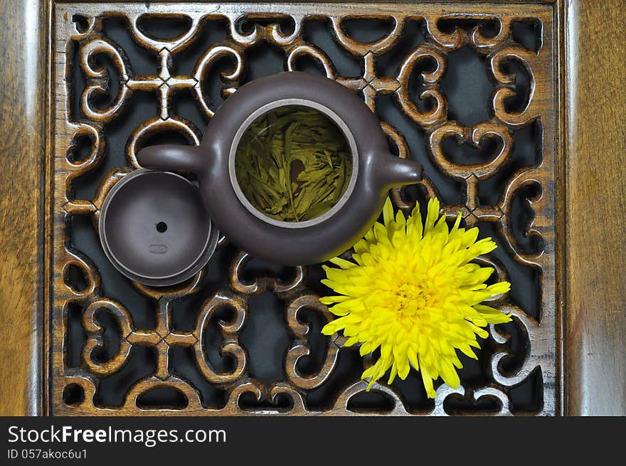 Green tea, chrysanthemum on carved woodwork