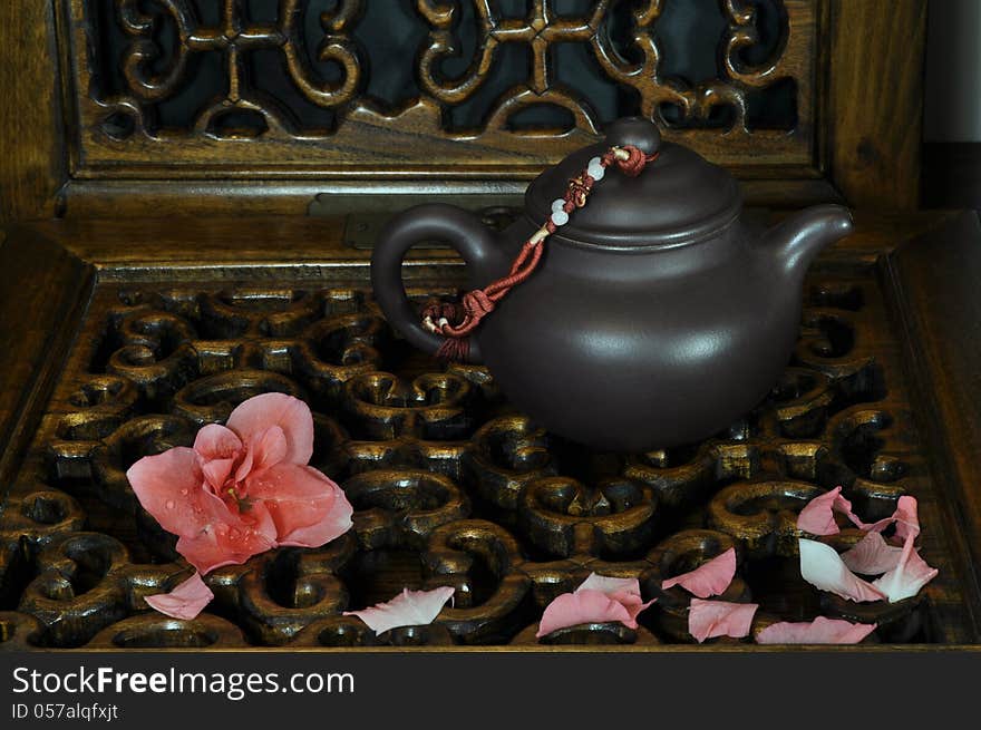 Tea pot and falling flowers