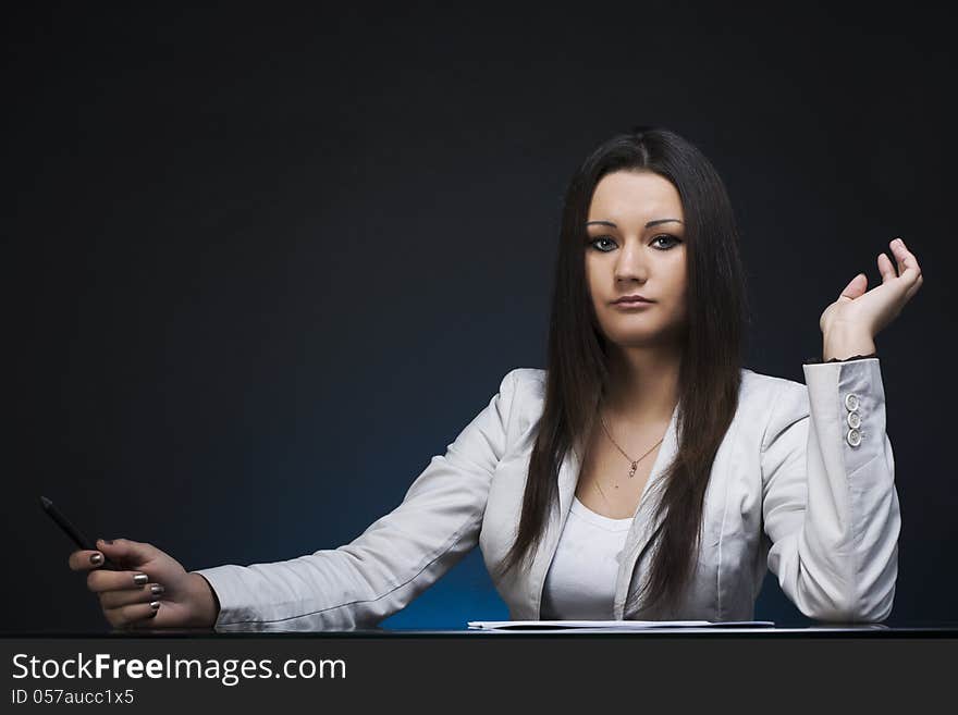 A business woman at a meeting table. A business woman at a meeting table.