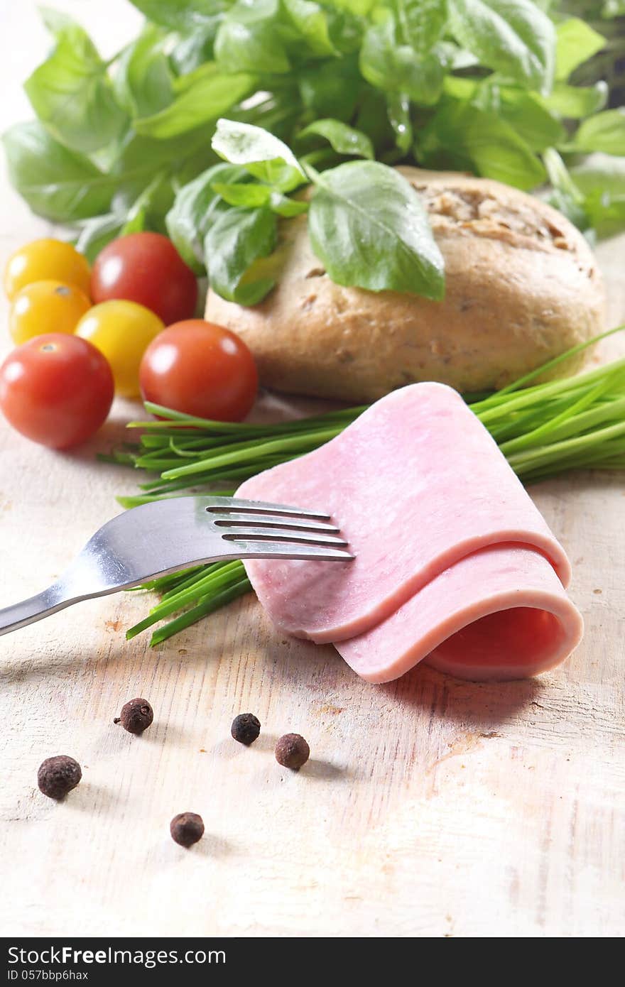 Vegetables, tomatoes, bread and meat on a fork. Vegetables, tomatoes, bread and meat on a fork.