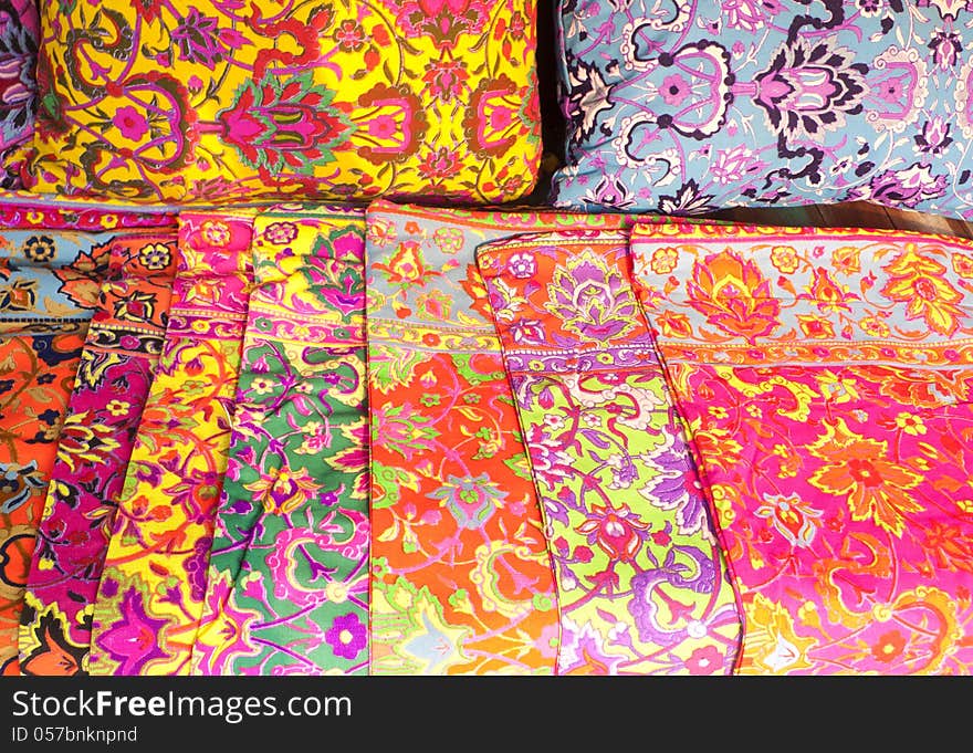 Piles of colorful pillowcase in a marketplace.