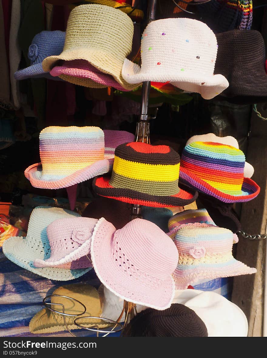 Colorful woven hat hanging on shop.