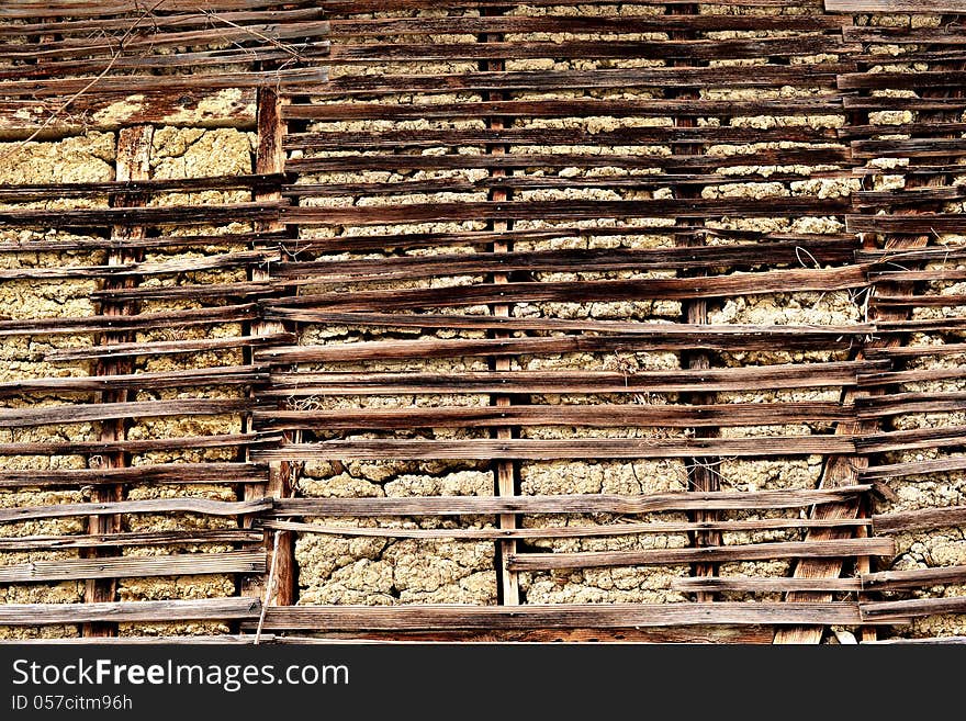 Primitive mud-brick wall of a house, background, texture. Primitive mud-brick wall of a house, background, texture