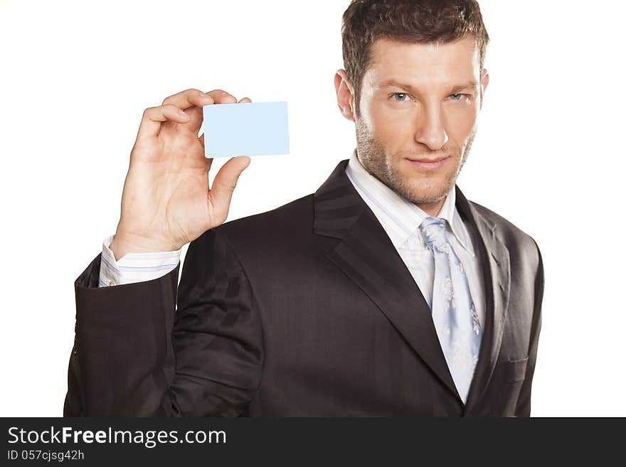 Smiling handsome businessman showing a credit card. Smiling handsome businessman showing a credit card