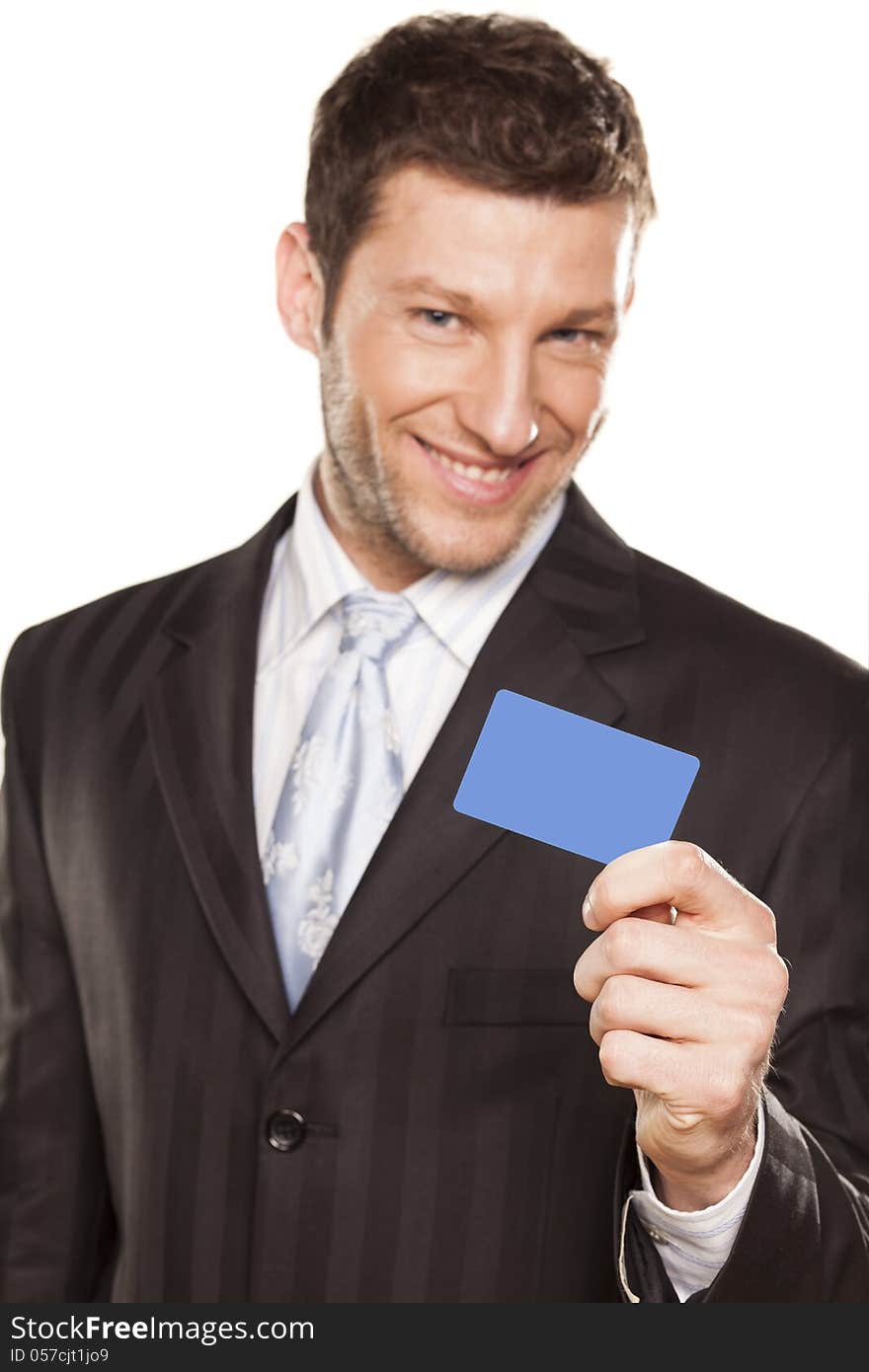 Smiling handsome businessman showing a credit card. Smiling handsome businessman showing a credit card