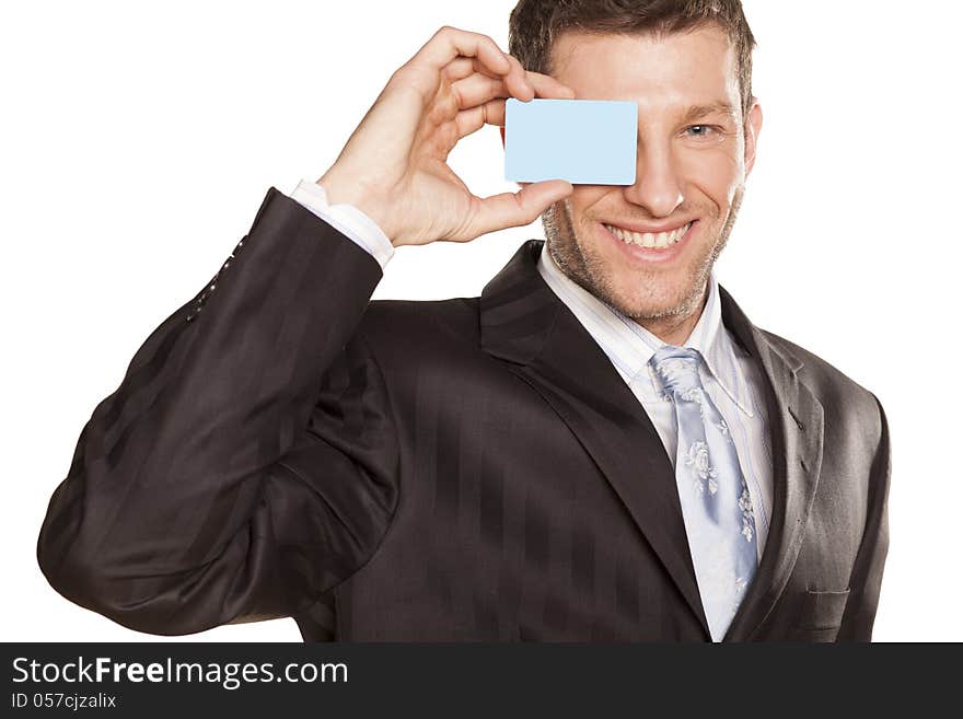 Smiling handsome businessman showing a credit card. Smiling handsome businessman showing a credit card