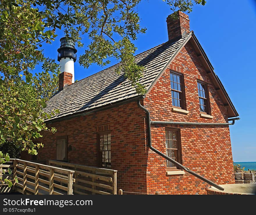 Lighthouse keepers house with lighthouse in the background. Lighthouse keepers house with lighthouse in the background