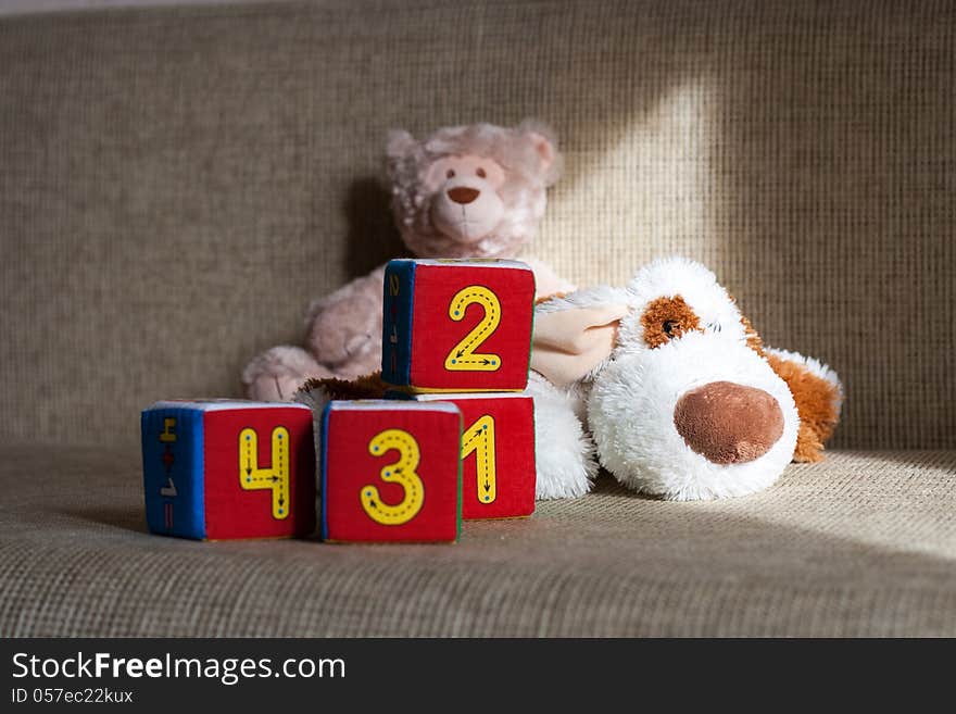 Teddy bear, dog and cubes with number one, two, three, four. Teddy bear, dog and cubes with number one, two, three, four