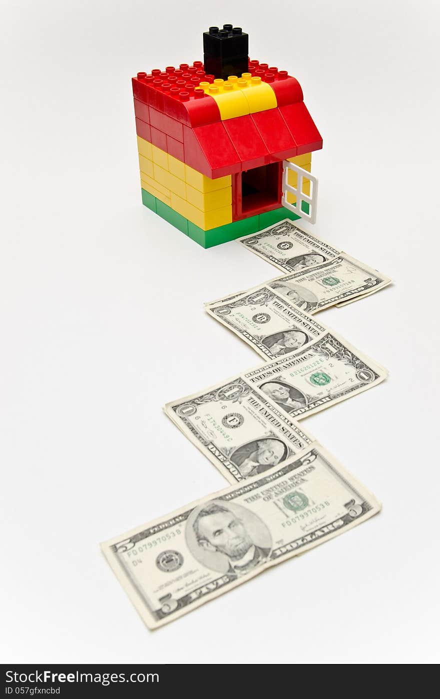 LEGO house and money. Dollars in front of the house. LEGO house and money. Dollars in front of the house.