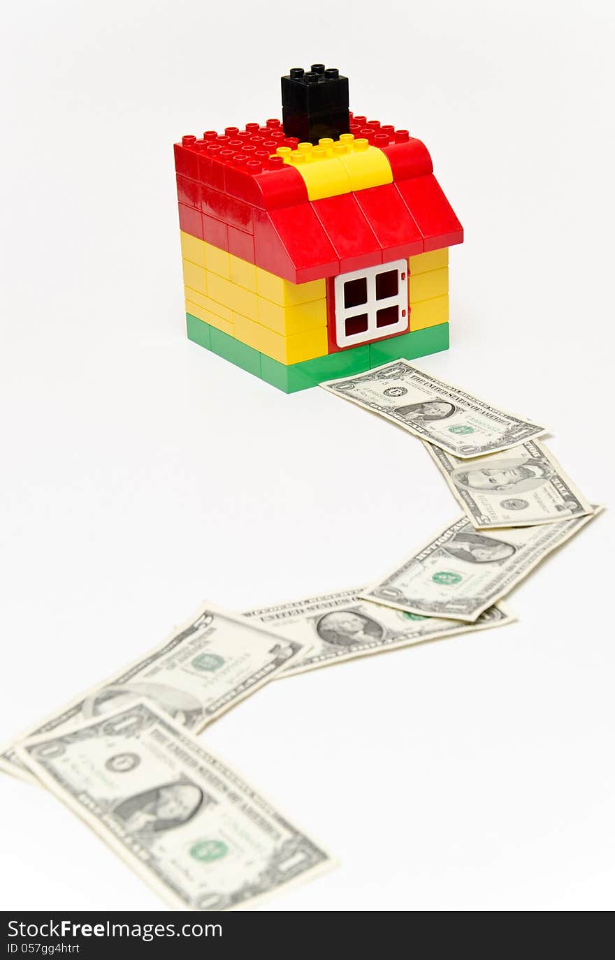 LEGO house and money. Dollars in front of the house. LEGO house and money. Dollars in front of the house.