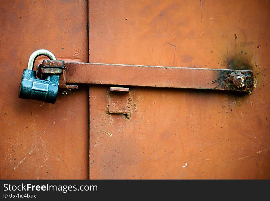 Old metal door closed on the lock. Old metal door closed on the lock