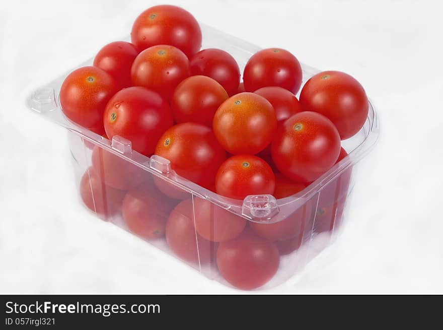 Set tomatoes in a transparent plastic bag isolated on white