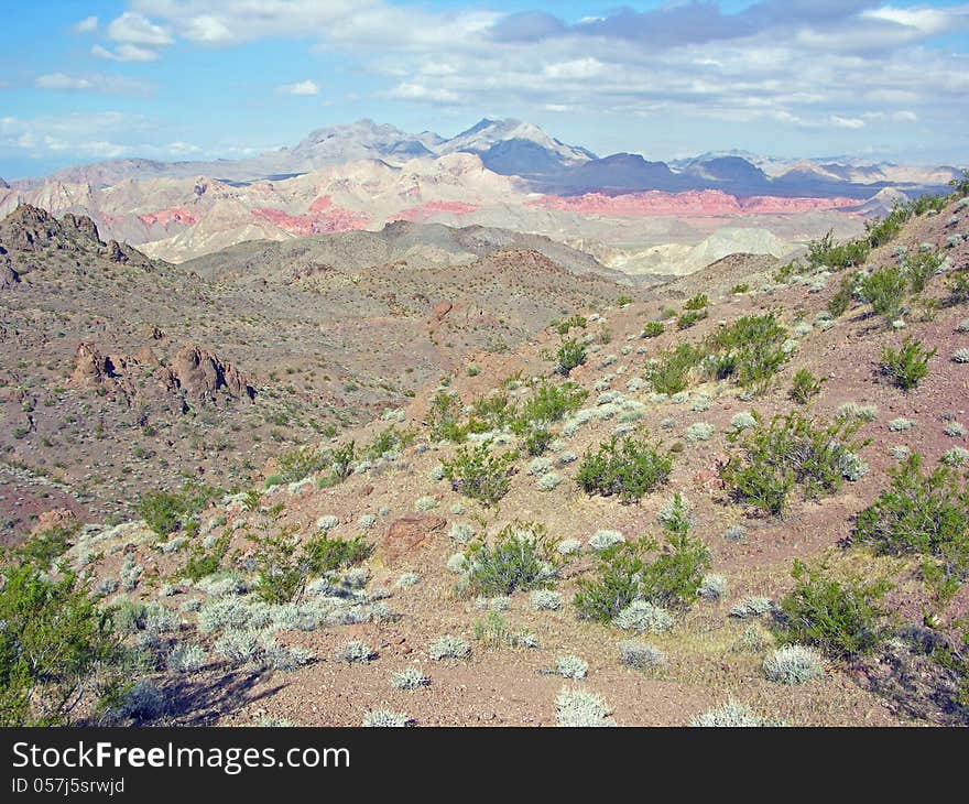 Scenic view of Bowl of Fire, in the background, from the Hamblin Peak area near Lake Mead, Nevada. The Bowl of Fire is west of the Valley of Fire State Park. Scenic view of Bowl of Fire, in the background, from the Hamblin Peak area near Lake Mead, Nevada. The Bowl of Fire is west of the Valley of Fire State Park