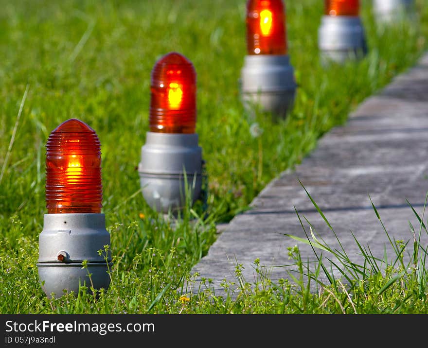 Close-up of guide lights next a helicopter landing pad. Close-up of guide lights next a helicopter landing pad