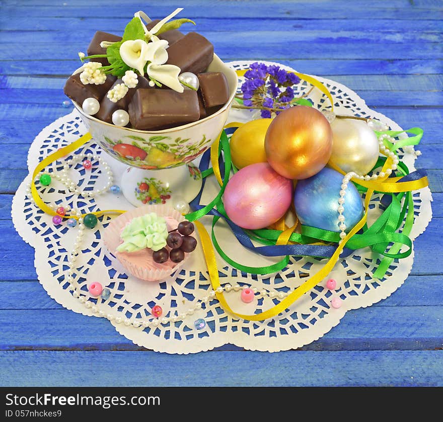 Five easter eggs with chocolate and berries on the napkin