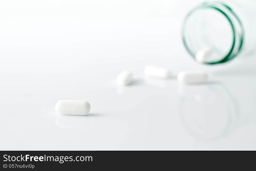 White oval pills spilled onto the counter