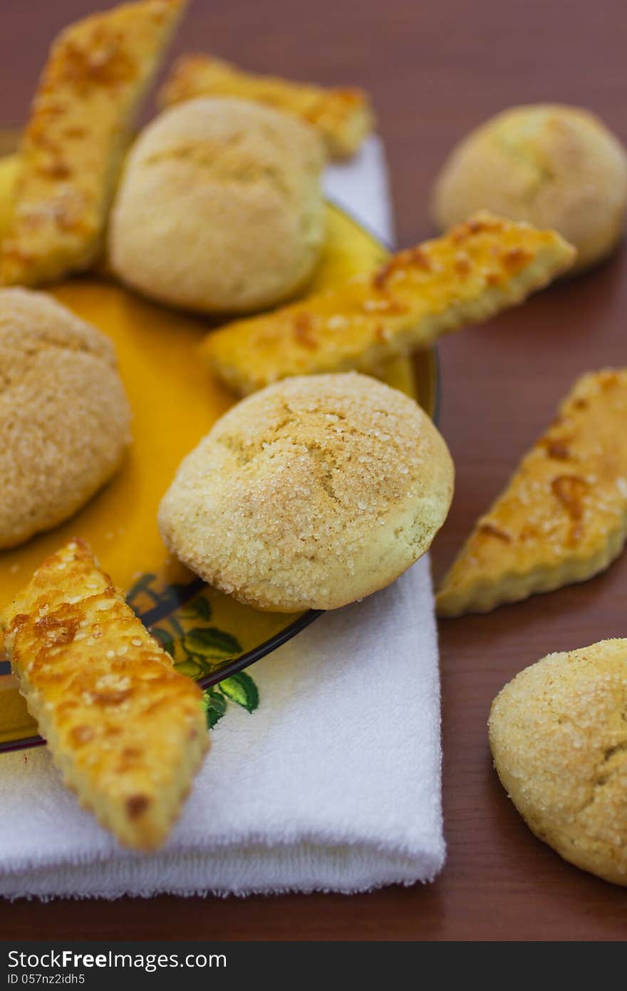 Delicious fresh baked cookies in plate and on table.