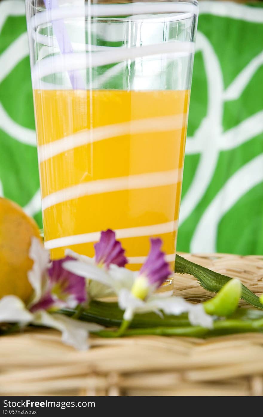 Glass of fresh orange juice put with flower