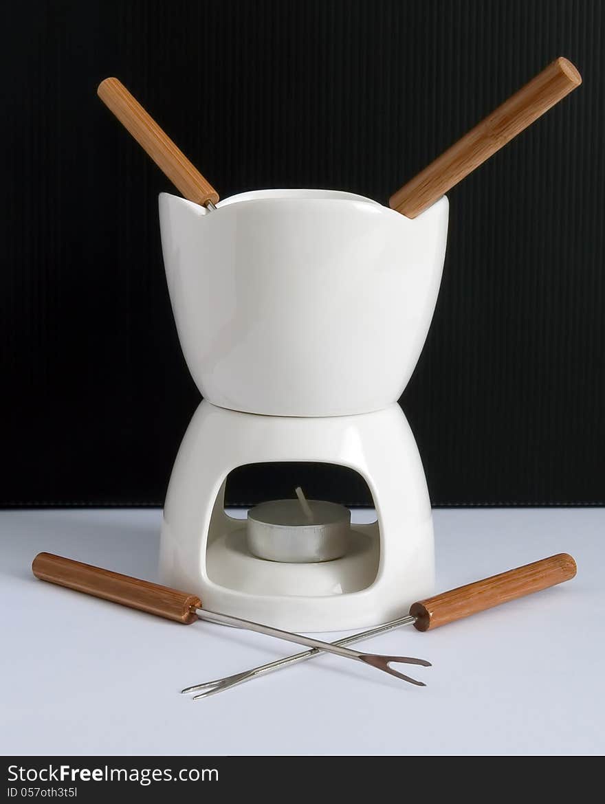 Fondue is a Swiss, French and Italian dish of melted cheese served in a communal pot  over a portable stove. Fondue is a Swiss, French and Italian dish of melted cheese served in a communal pot  over a portable stove.