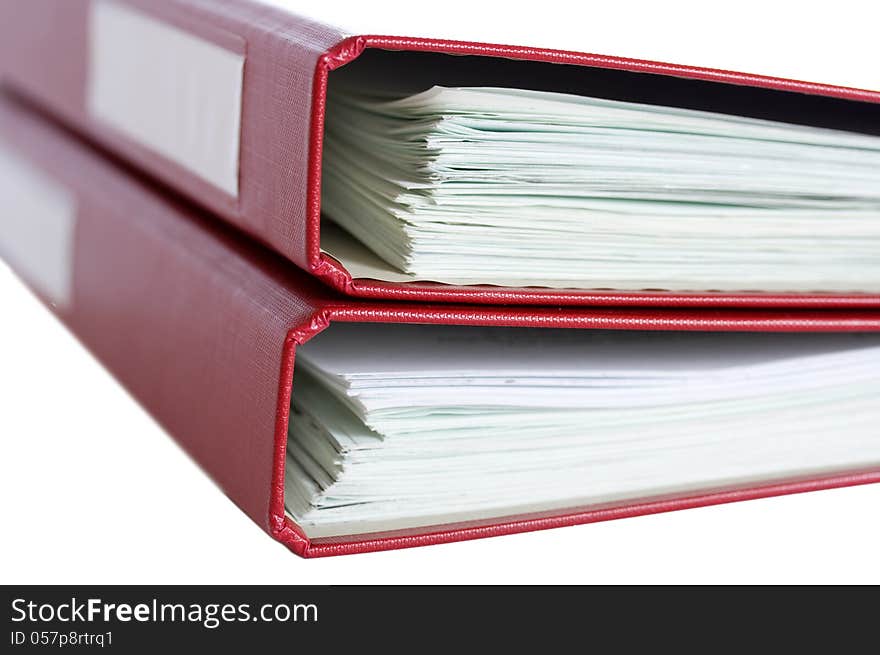 Stack of red folders with papers on white background