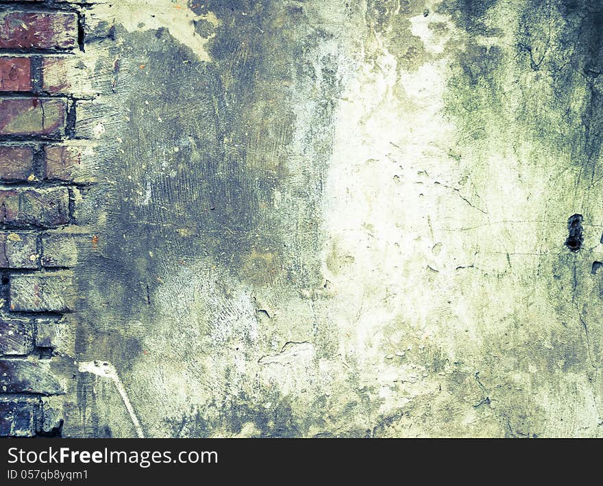 Grunge Background. The Old Brick Wall which has been Partially Covered with Concrete with Cracks and Dirt Spots.