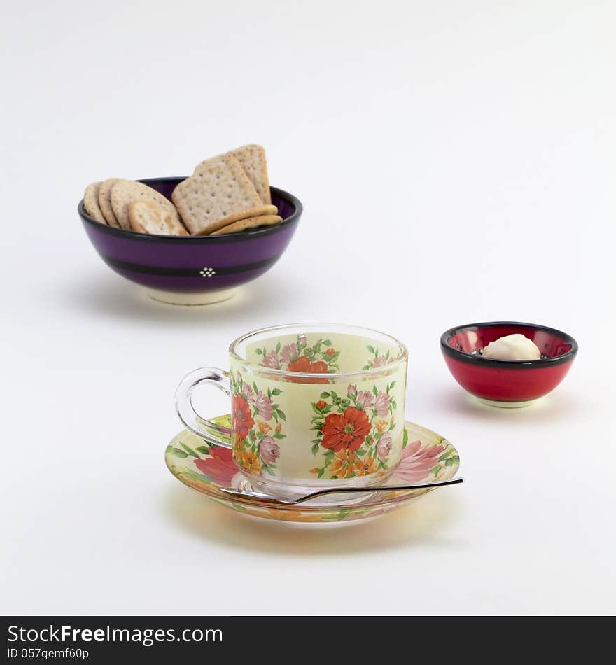 Cup with saucer and bowl with cookies