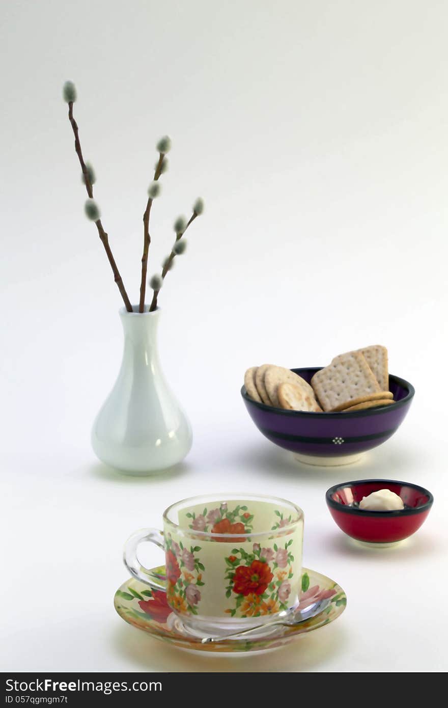 Tea cup, cookies, chocolates and a vase