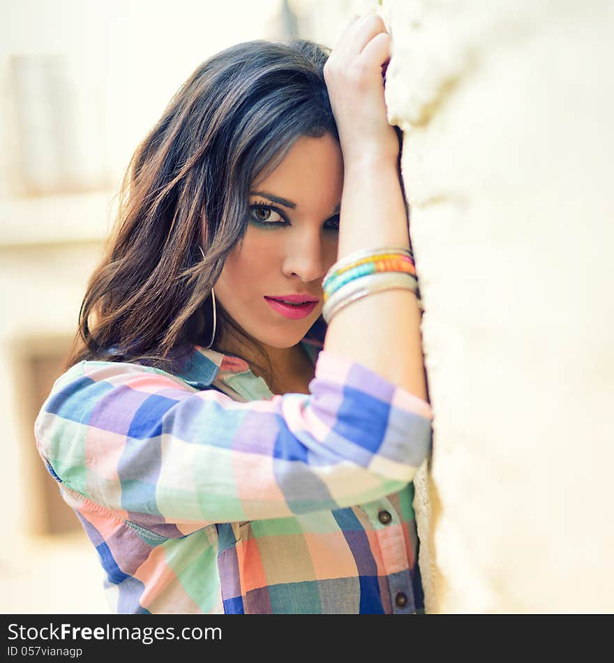 Portrait of a young beautiful woman in a urban background