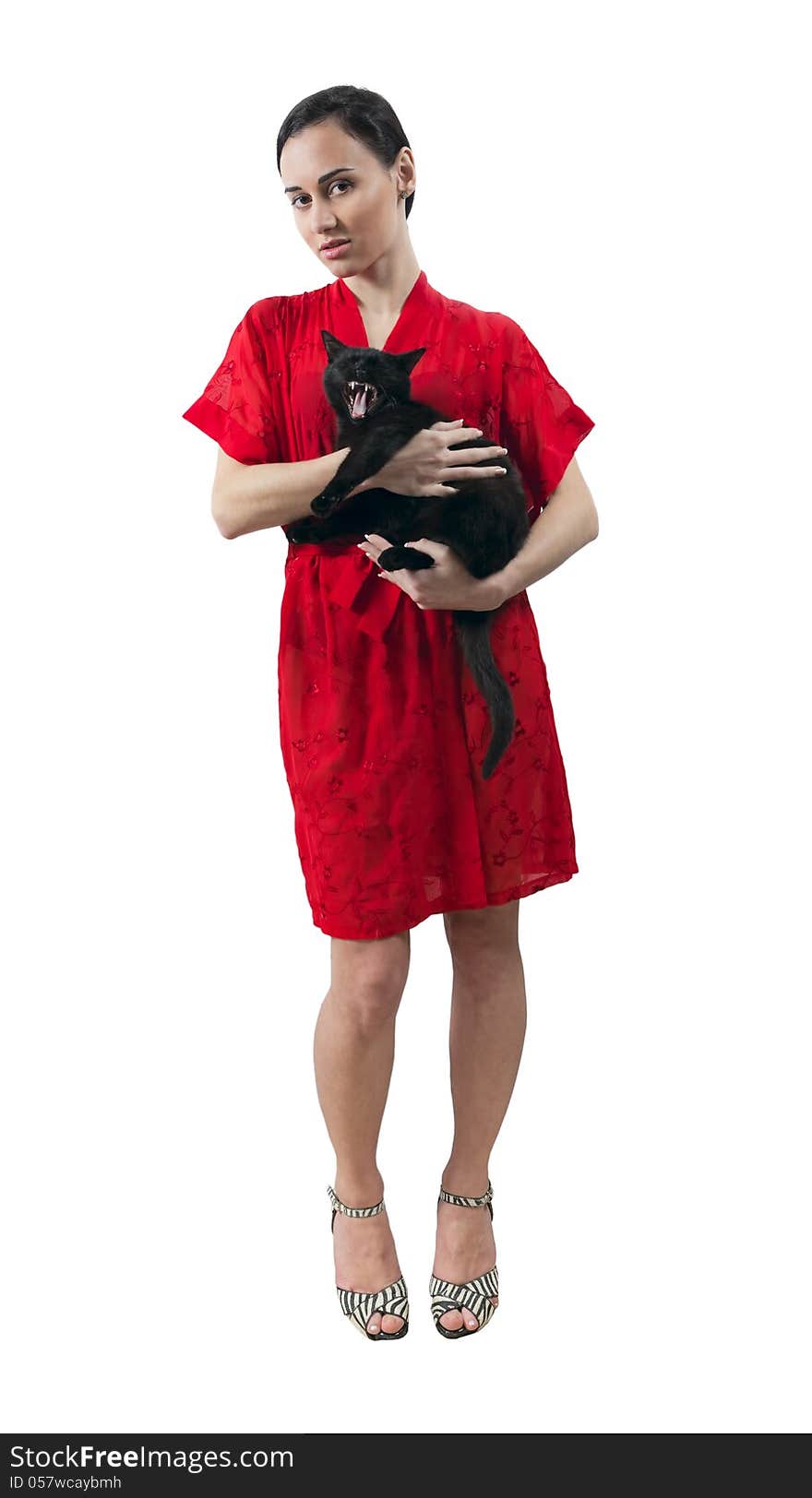 Young girl in red dressing gown with kitten isolated white