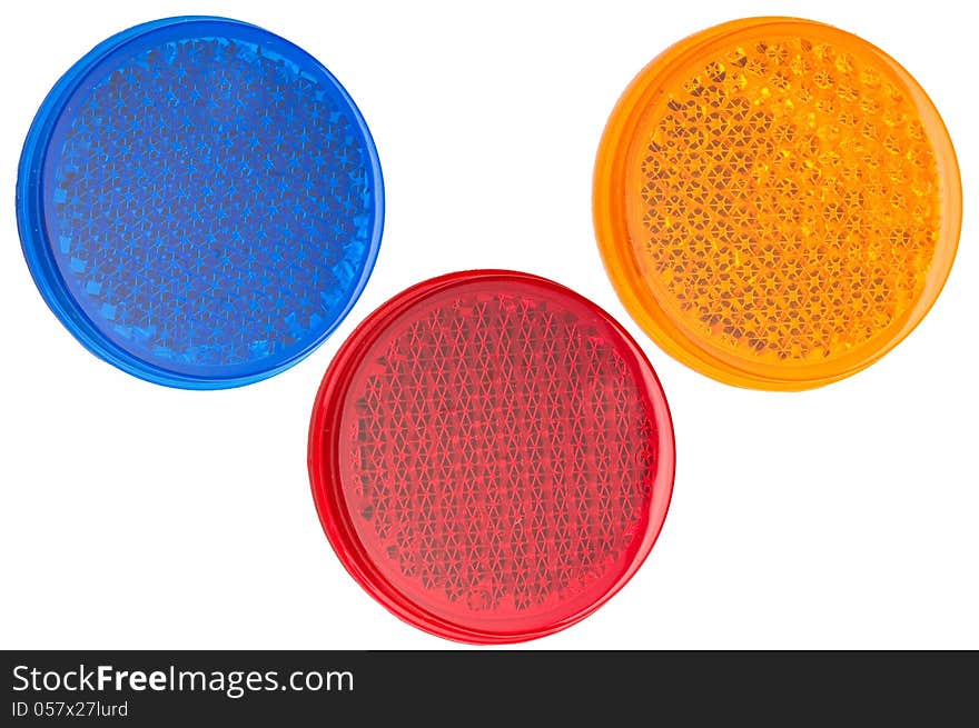 Red, blue, and yellow round reflectors isolated on white background. Red, blue, and yellow round reflectors isolated on white background.