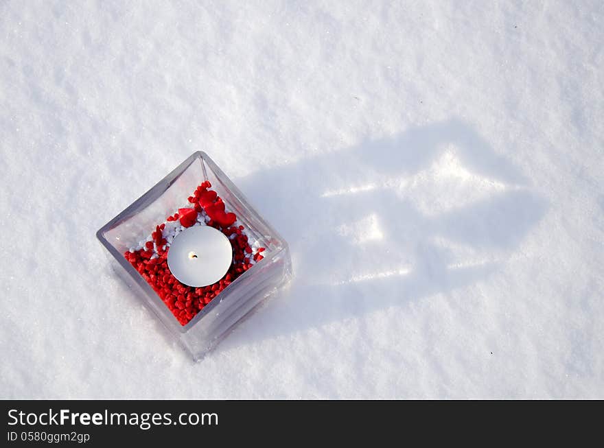 Candle with red decoration in winter