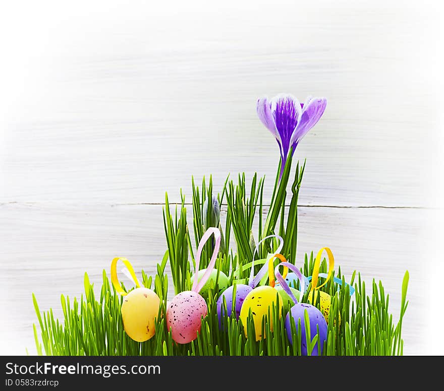 Art easter card with eggs, grass and spring flowers on wooden background for design or greating card. Art easter card with eggs, grass and spring flowers on wooden background for design or greating card