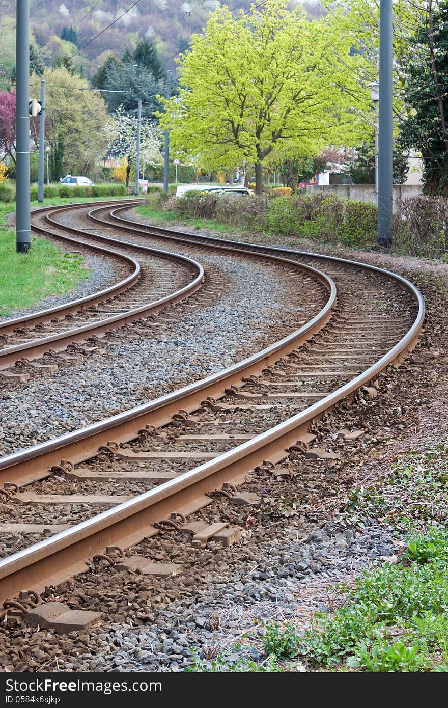 Curved tram rails in spring landscape