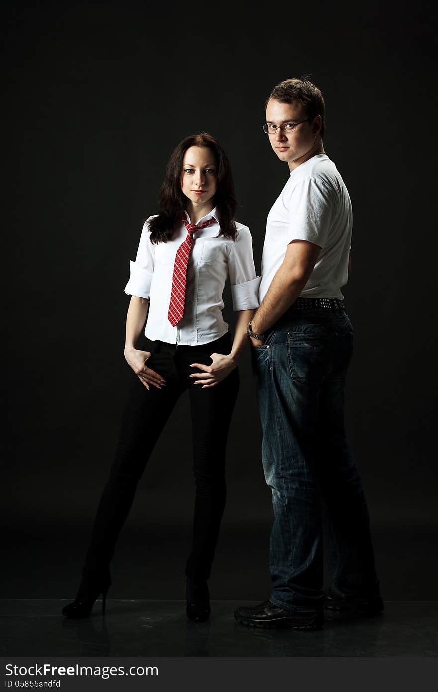 Handsome young couple posing standing in studio. Handsome young couple posing standing in studio