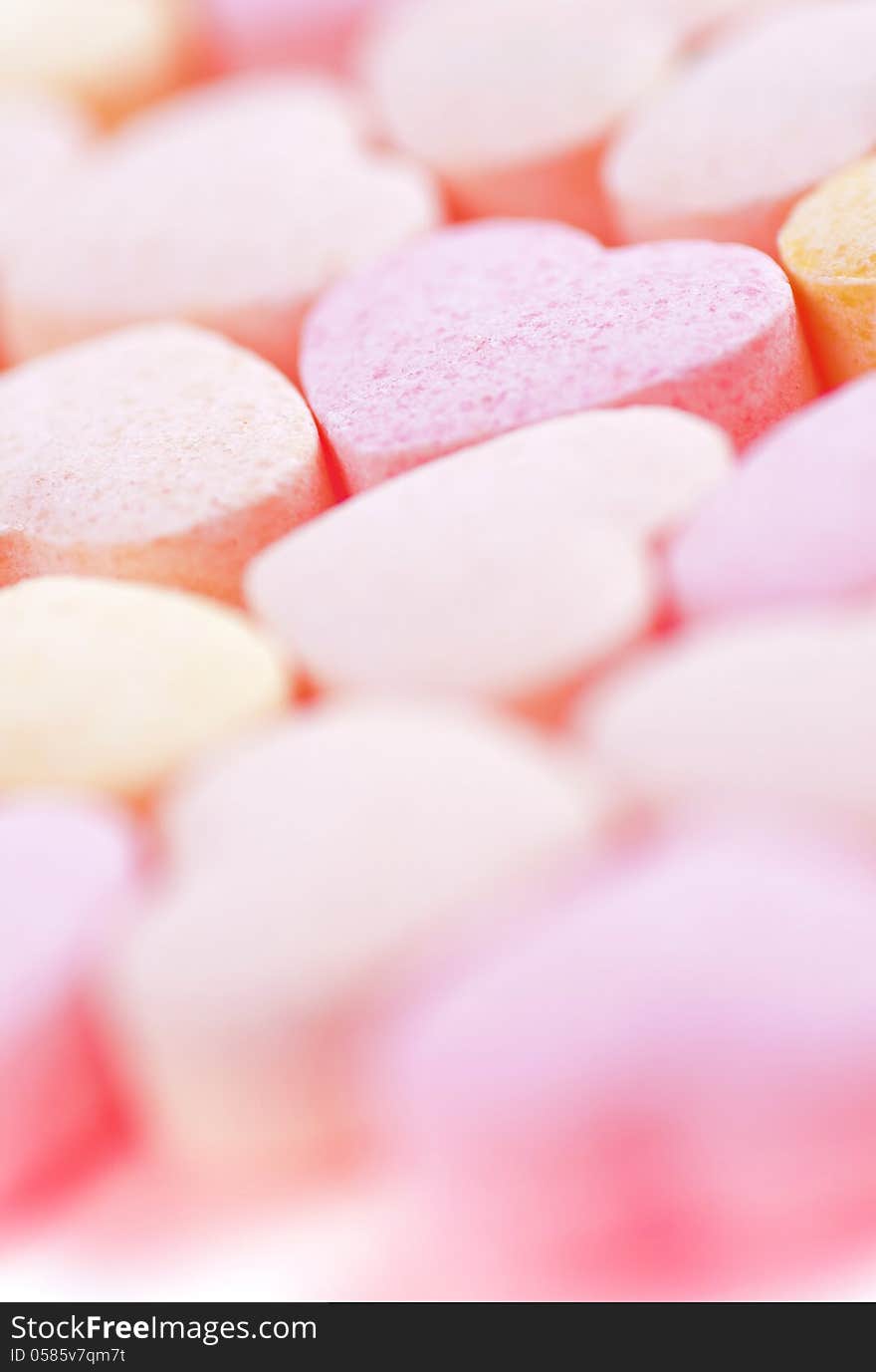 Sweet hearts shaped pink and orange Sugar Pills. Soft Focus. Sweet hearts shaped pink and orange Sugar Pills. Soft Focus.