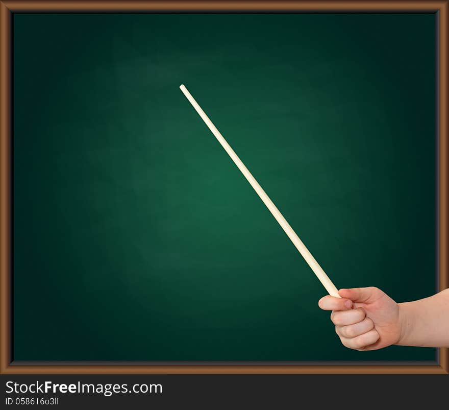 Hands of a child with a pointer on a green blackboard background