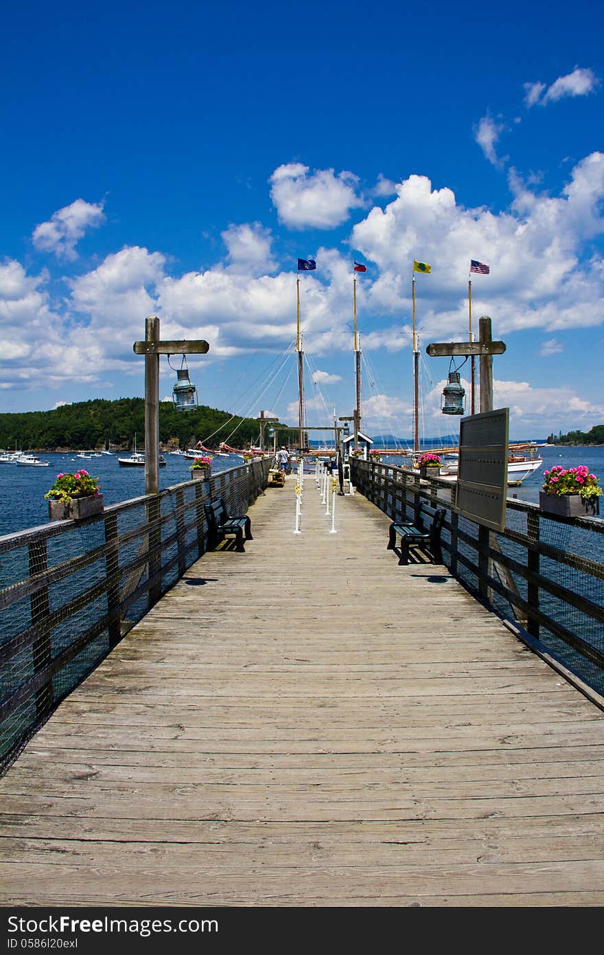 Boardwalk leading to boat with flags