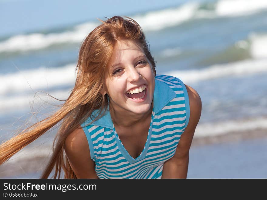 Portrait of a laughing girl at the beach