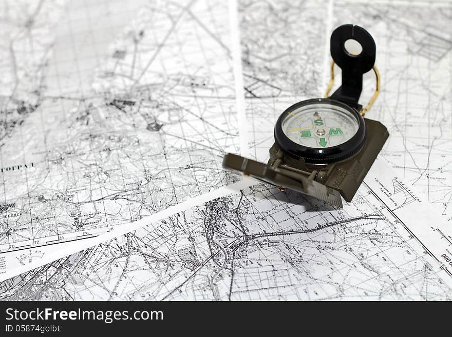 Compass on the background black-and-white city maps. Compass on the background black-and-white city maps