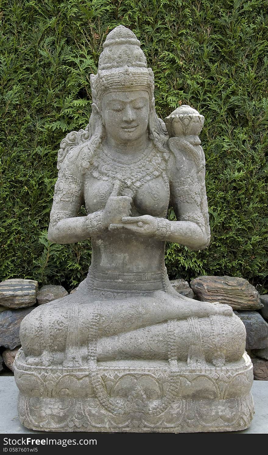 Buddha of grey stone with green background