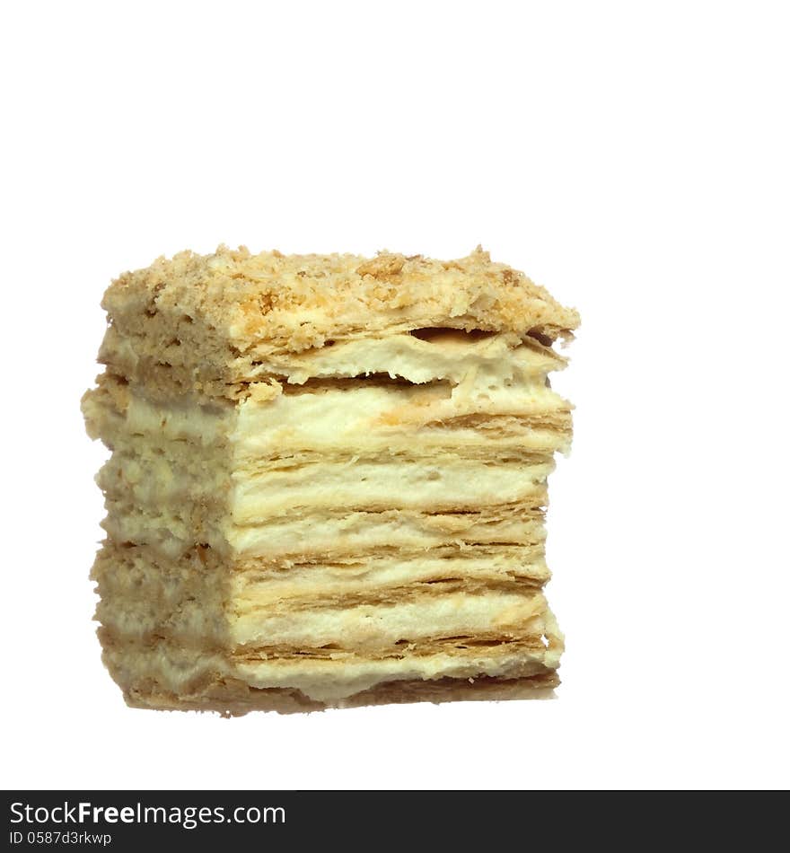 Slice of layer cake with custard, isolated on white