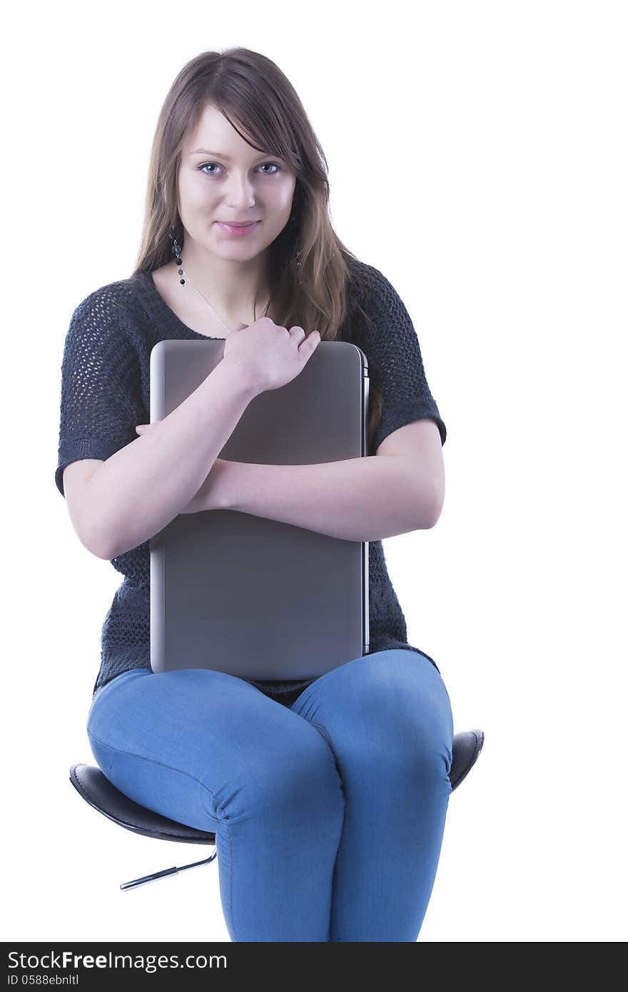 Casual student with computer in her lap. Isolated in our studio. Casual student with computer in her lap. Isolated in our studio.