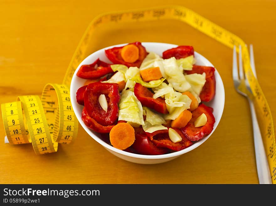 Bowl with vegetables on table. Bowl with vegetables on table.