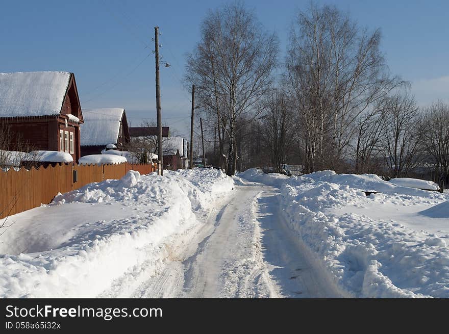 Road among the snowdrifts in Russian village. Road among the snowdrifts in Russian village