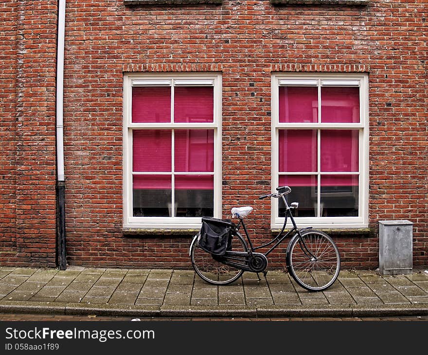 A classic bicycle against brick wall at streets of Middelburg, Netherlands. A classic bicycle against brick wall at streets of Middelburg, Netherlands.