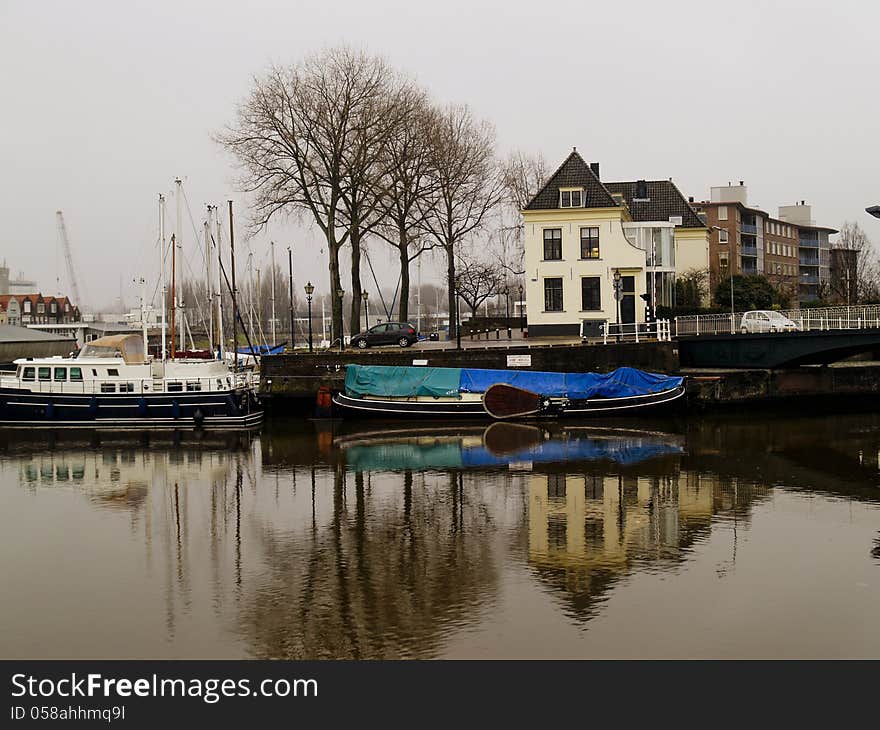 A typical view of city canals with boats and classic buildings. A typical view of city canals with boats and classic buildings.