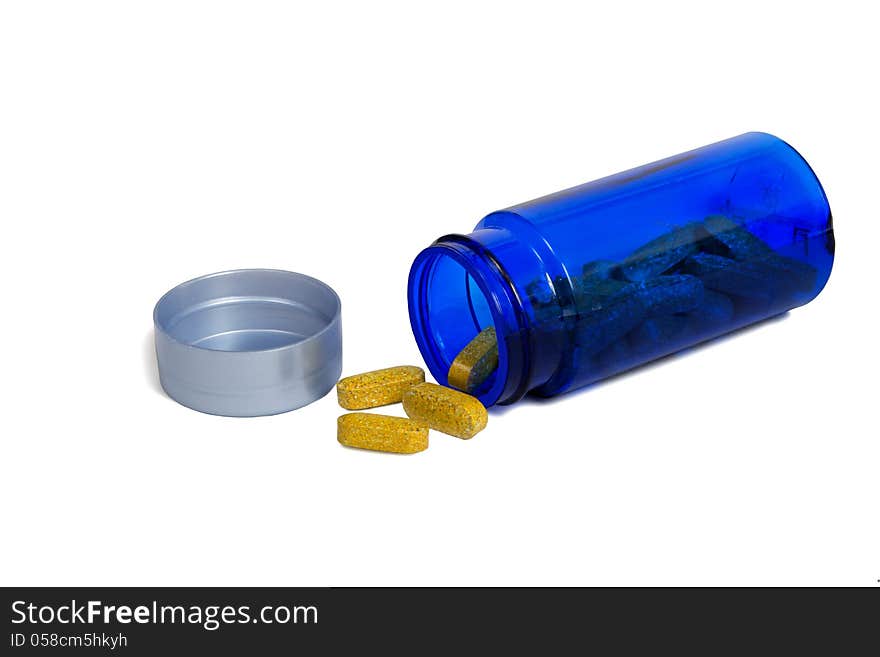 Nice horizontal close up shot of a blue bottle laying on its side and spilling healthy vitamins. on a white background. Plenty room for copy space. Nice horizontal close up shot of a blue bottle laying on its side and spilling healthy vitamins. on a white background. Plenty room for copy space.