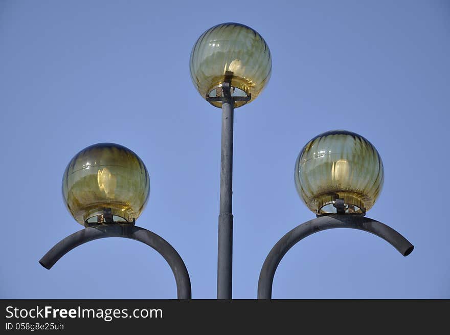 Park lights on the background of blue sky