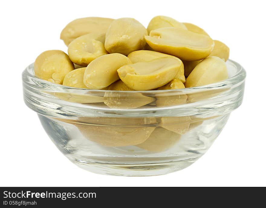 Peanuts in glass plate isolated on white