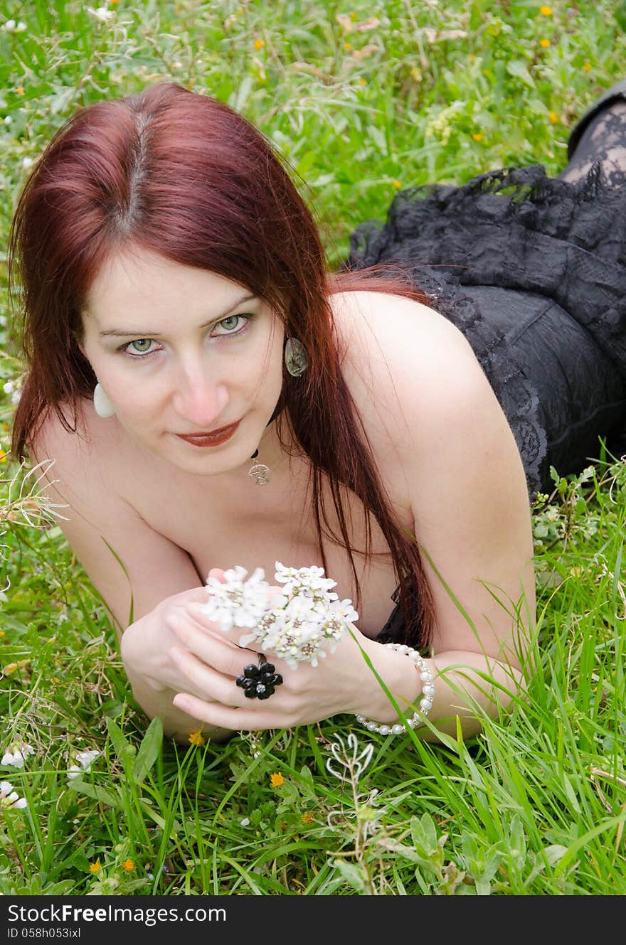 Woman with the white bouquet relaxing in the grass